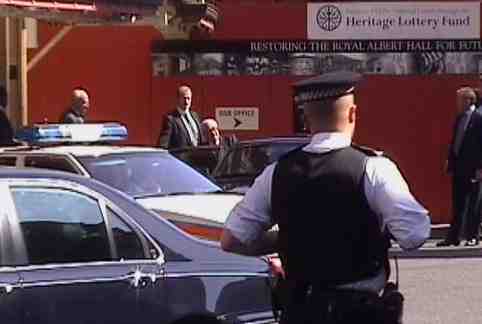 Henry Kissinger gets into his waiting car outside the Royal Albert Hall